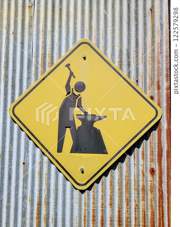 Blacksmithing Sign on Rusty Metal Wall Eye Level View Blacksmithing Sign on Rusty Metal Wall Eye Level View 122579298