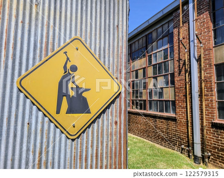 Industrial Caution Sign on Corrugated Metal Eye-Level Perspective Industrial Caution Sign on Corrugated Metal Eye-Level Perspective 122579315