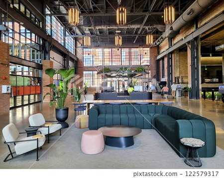 Modern Coworking Space with Green Sofa and Industrial Design at Eye Level 122579317