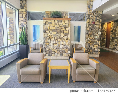 Modern Office Waiting Area with Stone Wall and Natural Light Eye-Level View 122579327