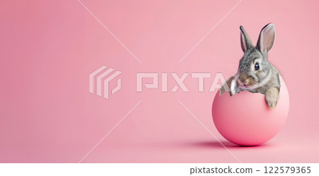 Easter bunny in cracked egg. Playful banner poster for Easter advertising 122579365