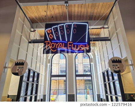 Royal Flush Neon Sign in Modern Bar with King Motifs Eye-Level View Royal Flush Neon Sign in Modern Bar with King Motifs Eye-Level View 122579416