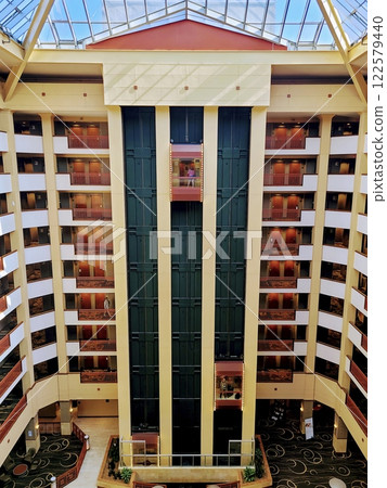 Glass Elevator and Balconies in Modern Hotel Atrium Aerial 122579440