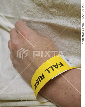 Fall Risk Wristband on Patient Wrist Eye-Level Perspective Fall Risk Wristband on Patient Wrist Eye-Level Perspective 122579458