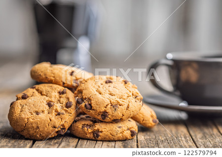 Chocolate chip cookies on wooden table. 122579794
