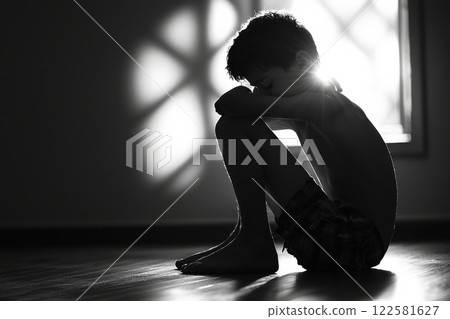Child's reflection on loneliness indoor space black and white photography natural light side view emotional depth 122581627