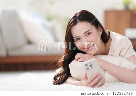 A woman using a smartphone A woman using a smartphone 122581786