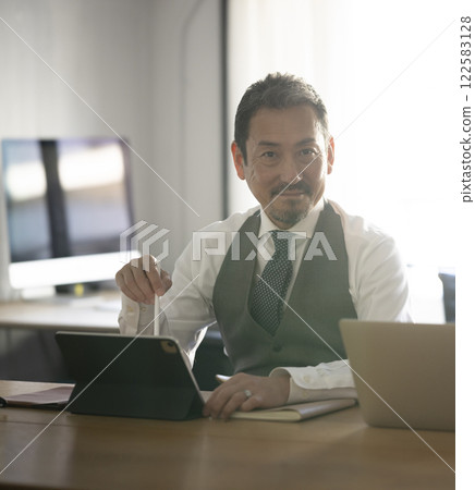 Middle-aged businessman using a computer 122583128