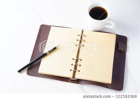 An image of working at a desk with a ring-type notebook open while drinking freshly brewed coffee. An image of working at a desk with a ring-type notebook open while drinking freshly brewed coffee. 122583369