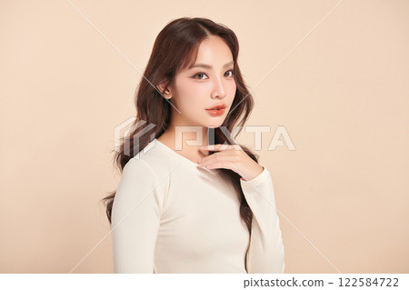 Beautiful young asian woman with clean fresh skin on beige background, Face care, Facial treatment, Cosmetology, beauty and spa, Asian women portrait. 122584722