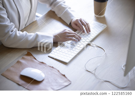 The hands of a woman working on a desktop computer The hands of a woman working on a desktop computer 122585160