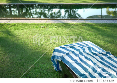 Pool towel on deckchair. 122585386