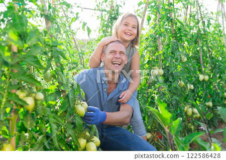 Dad and daughter gardening together 122586428