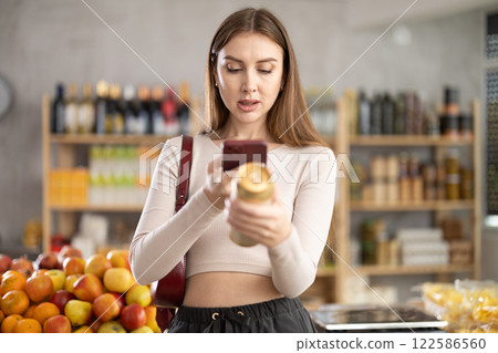 Young woman scanning qr code of beer Young woman scanning qr code of beer 122586560