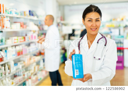 Female pharmacist with sanitizer in drugstore Female pharmacist with sanitizer in drugstore 122586902