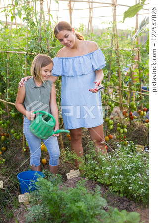 Mother and daughter in garden 122587026