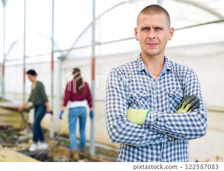 Man in a greenhouse 122587083