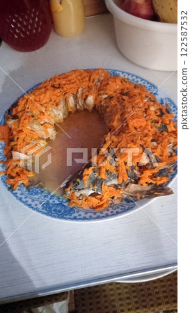 Stuffed jellied fish on a plate with carrots Stuffed jellied fish on a plate with carrots 122587532