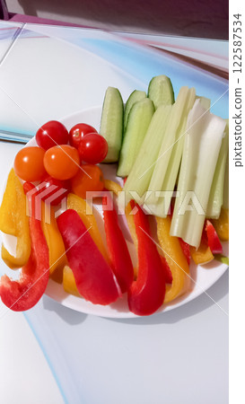Fresh vegetables on a plate peppers tomatoes cucumbers and celery Fresh vegetables on a plate peppers tomatoes cucumbers and celery 122587534