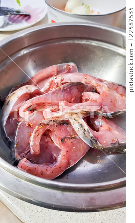 Cooked meat cut into pieces lies on a plate 122587535