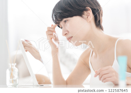 A middle-aged woman doing anti-aging care A middle-aged woman doing anti-aging care 122587645