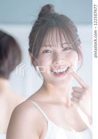 Young woman with straight teeth Young woman with straight teeth 122587677