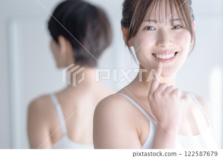 Young woman with straight teeth Young woman with straight teeth 122587679