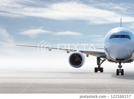 Front view of wide body passenger aircraft isolated on bright background with sky 122588157