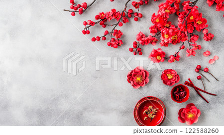 Red cherry blossoms and decorations on gray background 122588260