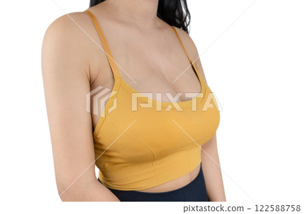 Woman with beautiful breasts sexy sport bra a yellow on a white background, closeup. Woman with beautiful breasts sexy sport bra a yellow on a white background, closeup. 122588758