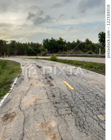 The road used for jogging in the park is damaged. The road used for jogging in the park is damaged. 122588916