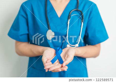 March Colorectal Cancer Awareness month, doctor with dark Blue Ribbon for supporting people living and illness. Healthcare, hope and World cancer day concept March Colorectal Cancer Awareness month, doctor with dark Blue Ribbon for supporting people living and illness. Healthcare, hope and World cancer day concept 122589571