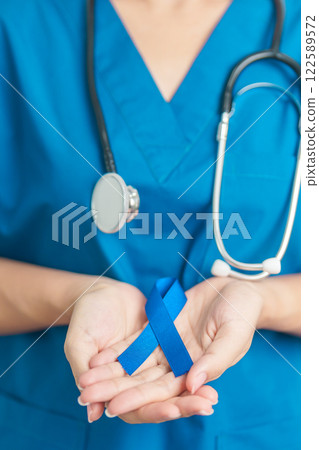 March Colorectal Cancer Awareness month, doctor with dark Blue Ribbon for supporting people living and illness. Healthcare, hope and World cancer day concept March Colorectal Cancer Awareness month, doctor with dark Blue Ribbon for supporting people living and illness. Healthcare, hope and World cancer day concept 122589572