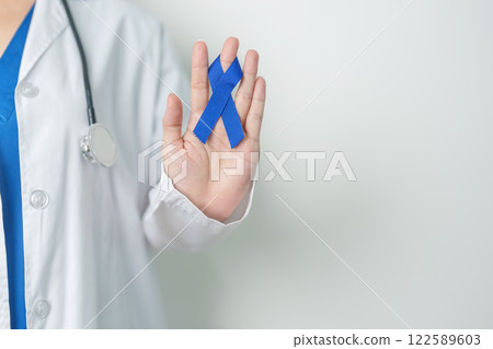 March Colorectal Cancer Awareness month, doctor with dark Blue Ribbon for supporting people living and illness. Healthcare, hope and World cancer day concept 122589603