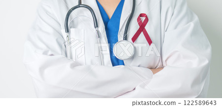 Doctor with Burgundy Red Ribbon for March multiple myeloma Cancer and December World Aids Day Awareness month. Healthcare and world cancer day concept Doctor with Burgundy Red Ribbon for March multiple myeloma Cancer and December World Aids Day Awareness month. Healthcare and world cancer day concept 122589643