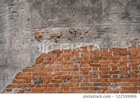 The walls are peeling the red bricks are visible texture background. 122589906