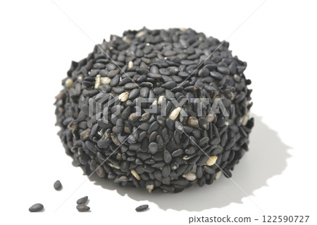 Black sesame balls photographed on a white background 122590727
