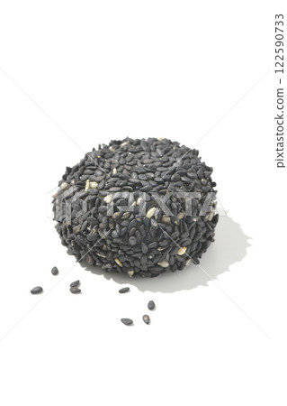 Black sesame balls photographed on a white background 122590733