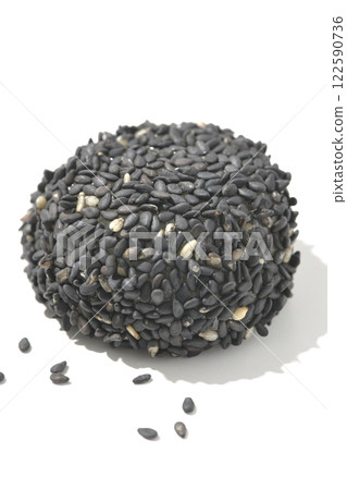 Black sesame balls photographed on a white background 122590736