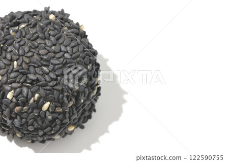 Black sesame balls photographed on a white background 122590755