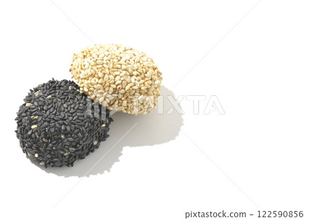 White and black sesame balls photographed on a white background 122590856
