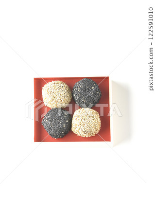 White and black sesame balls photographed on a white background 122591010