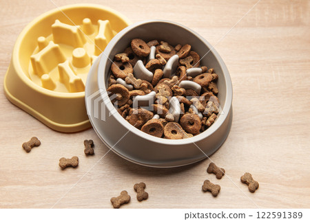Slow feeder bowls filled with dog kibble Slow feeder bowls filled with dog kibble 122591389