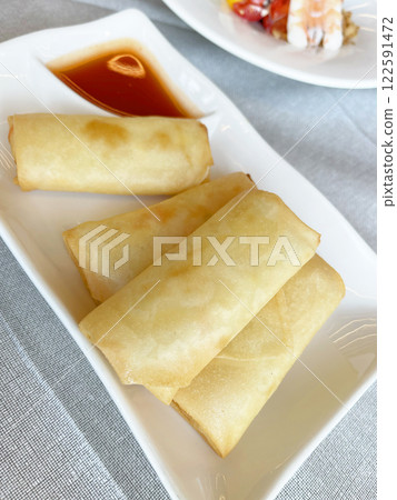Vegetarian spring roll with cabbage on plate with sauce. Asian cuisine. Healthy Eating.  122591472