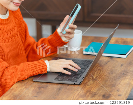 Women using laptops and smartphones Women using laptops and smartphones 122591819