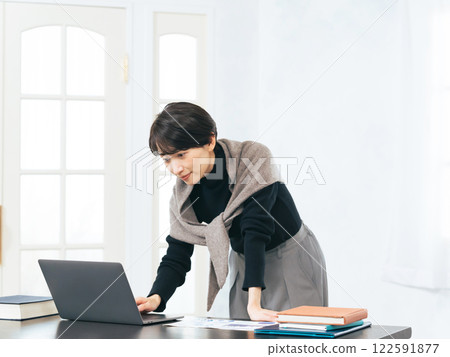 Middle-aged woman working at a desk 122591877