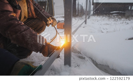 Professional worker performs welding work 122592179