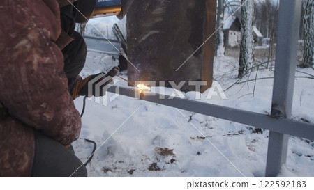Professional worker performs welding work 122592183