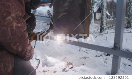 Professional worker performs welding work 122592201
