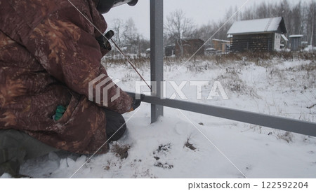 Professional worker performs welding work Professional worker performs welding work 122592204